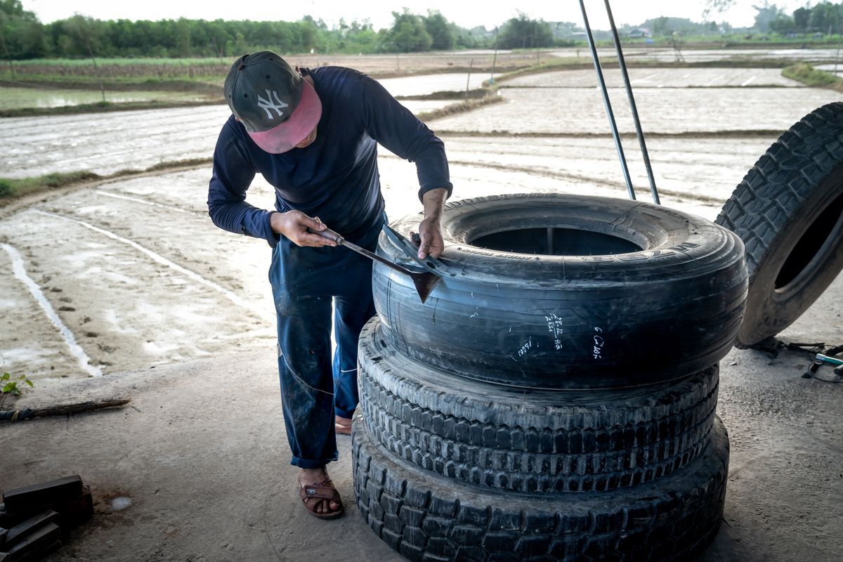 Technician mounting and repairing a tire